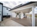 Charming covered front porch with seating area and stylish decor, adjacent to large garage at 2968 W Old Franklin Rd, Shelbyville, IN 46176