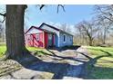 View of the colorful home showing the entrance, red accent wall and blue siding at 3142 N Euclid Ave, Indianapolis, IN 46218