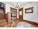 Elegant foyer showcasing hardwood floors, a staircase, and an ornate chandelier at 331 W State St, Pendleton, IN 46064