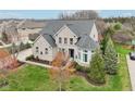 Beautiful aerial view showcases this home's pristine lawn and mature trees at 3892 Pelham Rd, Carmel, IN 46074