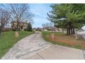 Long concrete driveway leading up to a beautiful home with a landscaped yard at 3901 S Meridian St, Indianapolis, IN 46217