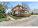 Beautiful two-story brick home with manicured lawn and mature landscaping at 3901 S Meridian St, Indianapolis, IN 46217