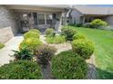 Landscaped front yard with lush greenery, flowers, and a small bird bath, leading to the home's entrance at 4043 Oak Trail Dr, Indianapolis, IN 46237