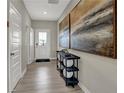 Inviting entryway featuring a console table with decor, artwork, and luxury vinyl plank flooring at 4523 Laughter Ln, Indianapolis, IN 46235