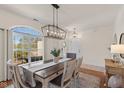 Elegant dining room featuring a modern light fixture and large window with a view at 4801 Copper Grove Dr, Indianapolis, IN 46237