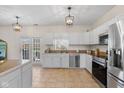 Bright kitchen with white cabinets, stainless steel appliances, and a view of the backyard at 4801 Copper Grove Dr, Indianapolis, IN 46237