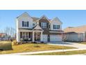 Inviting front porch with chairs creates a cozy entrance to this beautiful brick and siding home at 5387 Citadel Dr, Noblesville, IN 46062
