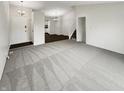 Spacious living room featuring a combination of carpet and hardwood flooring leading to the kitchen at 5927 Timber Lake Blvd, Indianapolis, IN 46237