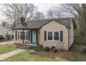 Attractive single-story home with tidy landscaping, neutral siding and a bright entry door at 631 E 86Th St, Indianapolis, IN 46240