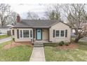 Charming tan-colored single-story home with a well-kept lawn and a vibrant blue front door at 631 E 86Th St, Indianapolis, IN 46240