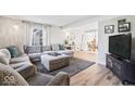 Comfortable living room featuring a large sectional sofa, neutral decor, and lots of natural light at 788 S Harbour Dr, Noblesville, IN 46062