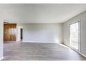 Bright living room features wood-look flooring and a large window for ample natural light at 7906 E 21St St, Indianapolis, IN 46219