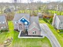 Expansive aerial view showcasing the home's layout and meticulously landscaped yard at 8228 Morel Dr, Indianapolis, IN 46256