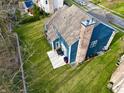 Aerial view of a spacious backyard, featuring a patio area and lush greenery at 8228 Morel Dr, Indianapolis, IN 46256