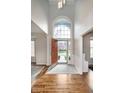 Inviting foyer with gleaming hardwood floors and a soaring arched window at 8228 Morel Dr, Indianapolis, IN 46256