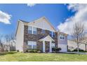 Charming two-story home featuring a brick facade, landscaped yard, and an attached garage at 8610 Fawn Way, McCordsville, IN 46055