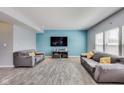 Spacious living room with two gray sofas and gray wood-look flooring at 8610 Fawn Way, McCordsville, IN 46055