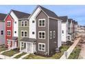 Modern townhomes featuring colorful exteriors, landscaped yards, and inviting front porches at 928 E 24Th St, Indianapolis, IN 46205