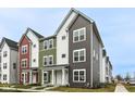 Modern townhomes with colorful exteriors and well-manicured front lawns, creating a vibrant streetscape at 928 E 24Th St, Indianapolis, IN 46205