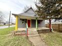 Exterior view of a gray house with a colorful front porch in a residential area at 980 Edgemont Ave, Indianapolis, IN 46208