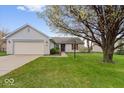 Charming single-story home with a well-maintained lawn, attached two-car garage, and inviting curb appeal at 9856 Commonwealth Dr, Fishers, IN 46038