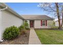 Charming single-story home with a well-maintained lawn, attached two-car garage, and inviting curb appeal at 9856 Commonwealth Dr, Fishers, IN 46038