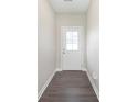The entry hall is features a sleek gray wood floor and a bright white entry door at 1239 Newton St, Avon, IN 46123