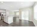 Bright, open-concept floor plan with gray wood floors, neutral walls, and sliding door at 1239 Newton St, Avon, IN 46123