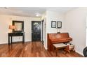 Warm and inviting foyer featuring hardwood floors, a console table, and a piano at 14060 Princewood Dr, Fishers, IN 46037