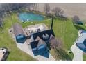 Aerial view of beautiful home featuring a large pond, outdoor patio, and a detached garage at 1471 S Frog Pond Ct, Greenfield, IN 46140