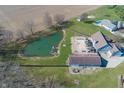 Overhead view of property with large pond, private backyard with pool and in-ground trampoline at 1471 S Frog Pond Ct, Greenfield, IN 46140
