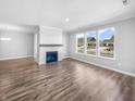 Spacious living room with hardwood floors, a cozy fireplace, and bright windows for natural light at 3124 Sharon Cir, Brownsburg, IN 46112