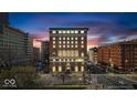 Striking exterior of a vintage brick building, illuminated by lights against the evening sky at 350 N Meridian St # 610, Indianapolis, IN 46204