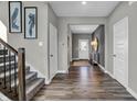 Inviting entryway boasts hardwood floors, staircase, and an open view into the home at 3587 Planck Cir, Danville, IN 46122