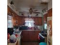 Functional kitchen with a ceiling fan, ample cabinet space, and a bright window view at 3701 N Audubon Rd, Indianapolis, IN 46218