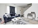 Living room with a modern blue couch, a white coffee table and a zebra-striped rug at 4135 Benicia Ln, Indianapolis, IN 46235