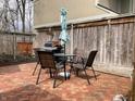 Brick patio with outdoor dining set and grill, ideal for enjoying outdoor meals at 4214 Woodsage Trce, Indianapolis, IN 46237