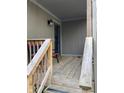 Covered porch with wooden deck, offering a cozy outdoor space with bench seating at 4214 Woodsage Trce, Indianapolis, IN 46237
