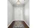 Inviting foyer featuring hardwood floors, a chandelier, and a decorative rug at 462 N Crystal Dr, Fortville, IN 46040