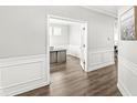 Bright home office featuring a modern desk, hardwood floors, white wainscoting, and large windows at 4763 Denton Dr, Zionsville, IN 46077
