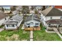 Aerial view of home featuring a cozy front porch, lush lawn, and close proximity to neighboring houses at 4933 Ford St, Indianapolis, IN 46224