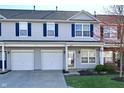 A beautiful townhome with an attached garage and a well-kept yard and garden at 4951 Tuscany Ln, Indianapolis, IN 46254