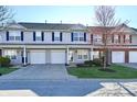 Attractive townhome featuring an attached garage, a well-manicured lawn, and tidy landscaping at 4951 Tuscany Ln, Indianapolis, IN 46254