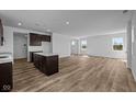 Open-concept kitchen featuring dark cabinetry, white countertops, and stainless steel appliances at 5208 Rolling Meadow Blvd, Indianapolis, IN 46237