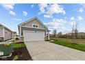 Inviting home with a two-car garage and a long concrete driveway at 5211 Rolling Meadow Blvd, Indianapolis, IN 46237
