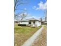 Cozy one-story home with a gravel driveway and a well-maintained lawn at 5225 S Linwood Ave, Indianapolis, IN 46237