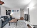A cozy living room featuring a comfortable blue couch and hardwood floors at 5225 S Linwood Ave, Indianapolis, IN 46237