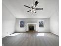 Bright living room with neutral carpet, a fireplace, and a ceiling fan at 603 Raintree Dr, Avon, IN 46123