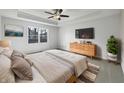 A relaxing main bedroom with large window, ceiling fan, dresser, and soft, neutral tones at 603 Raintree Dr, Avon, IN 46123