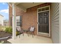 Front porch featuring brick facade, outdoor seating, and a welcoming entrance at 6916 Cobb Cir, Noblesville, IN 46062
